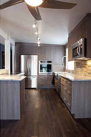Modern kitchen with dark wood cabinetry and granite countertops