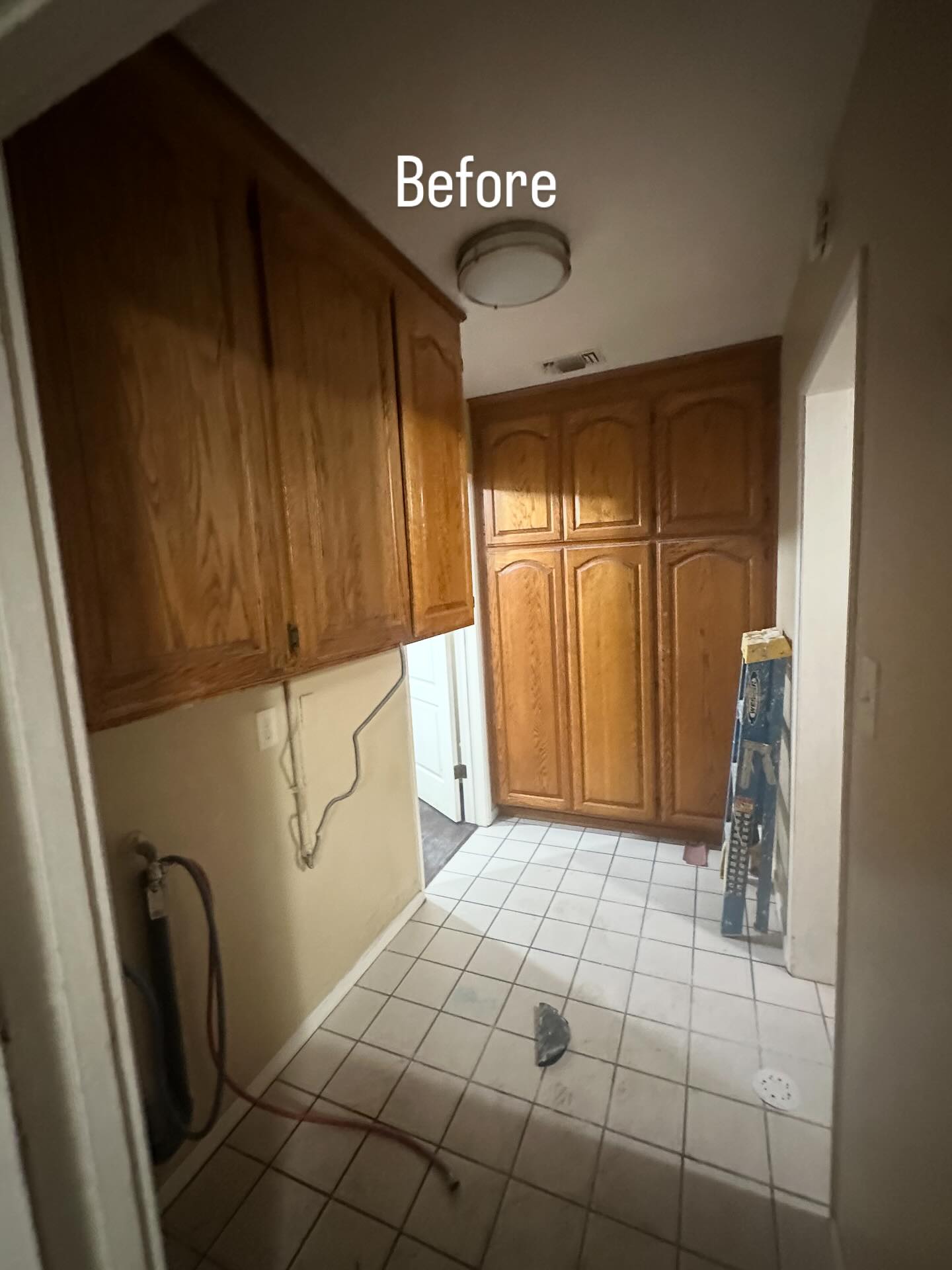 Kitchen before renovation with outdated oak cabinets
